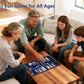 Family playing backgammon on navy blue foldable set at coffee table, ideal for family bonding and indoor entertainment.