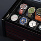 Close-up of 10-slot watch box interior, showing padded watch pillows and elegant glass top for display and protection.