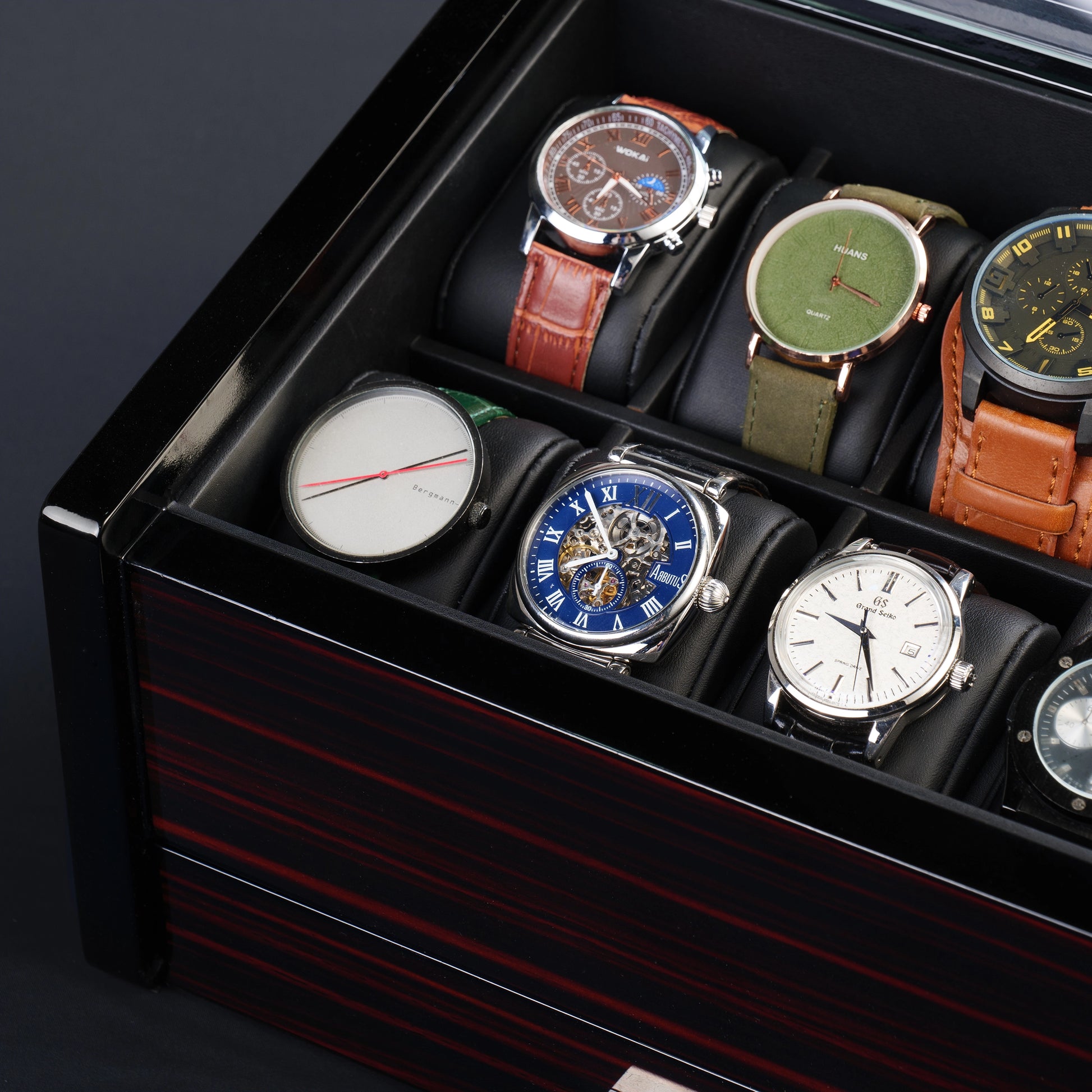 Close-up of 10-slot watch box interior, showing padded watch pillows and elegant glass top for display and protection.